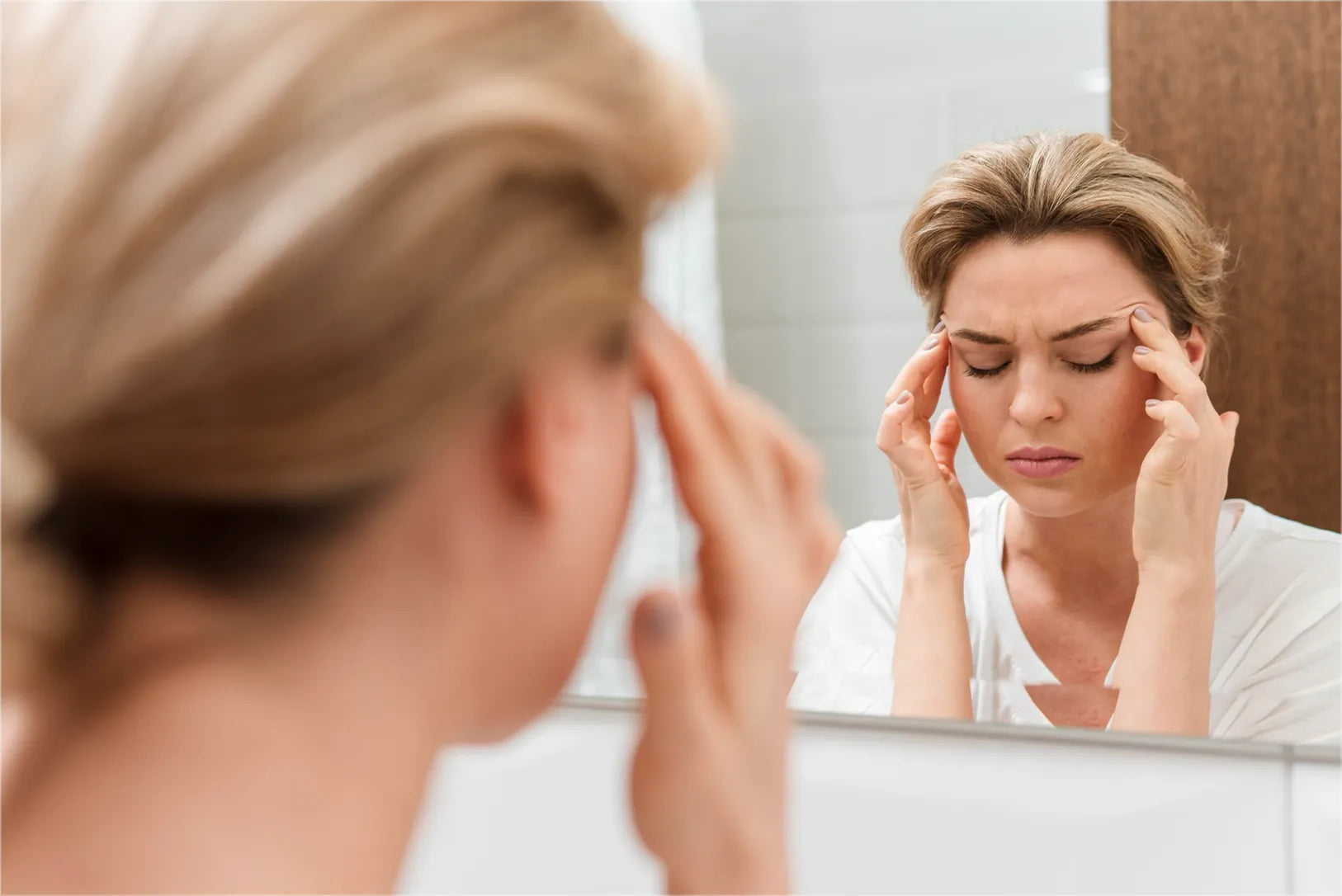 Woman looking in mirror